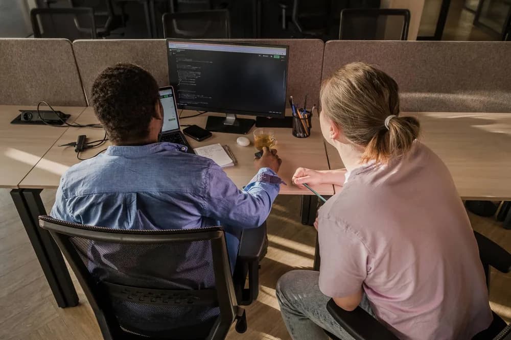 Two RST Forum students working through a lab exercise together at one screen